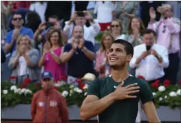  ?? PAUL WHITE — THE ASSOCIATED PRESS ?? Carlos Alcaraz, of Spain, celebrates after winning the final match against Alexander Zverev, of Germany, at the Mutua Madrid Open tennis tournament in Madrid, Spain, on Sunday.