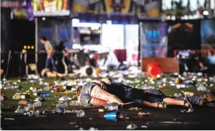  ?? — AFP ?? A person lies on the ground covered with blood at the Route 91 Harvest country music festival