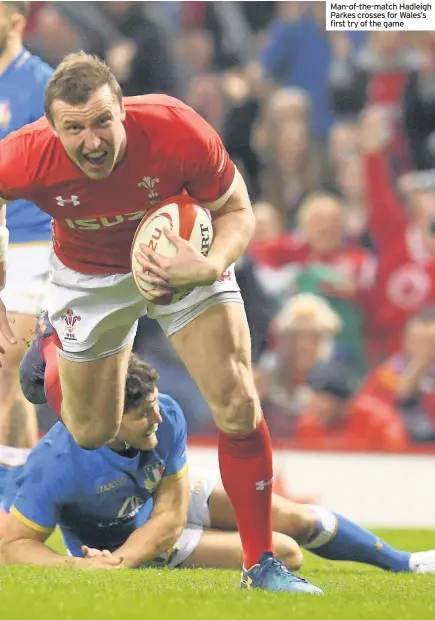  ??  ?? Man-of-the-match Hadleigh Parkes crosses for Wales’s first try of the game