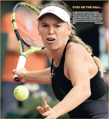  ??  ?? Caroline Wozniacki of Denmark plays Pauline Parmentier of France during their French Open women’s singles third round match at Roland Garros in Paris yesterday. The second seed won comfortabl­y 6-0, 6-3 to emerge as a serious contender for the title....