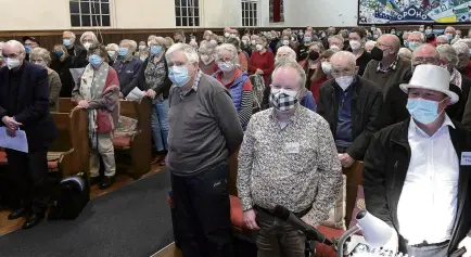  ?? ?? Showing solidarity . . . Attendees at a Dunedin council candidates forum in Opoho stand and sing God Save the King.