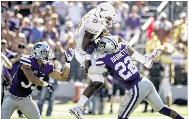  ?? RICARDO B. BRAZZIELL / AMERICAN-STATESMAN 2014 ?? Despite the efforts of John Harris (9) and the rest of the Longhorns in their 2014 matchup with K-State, Texas got blanked 23-0. The Longhorns looked sloppy in all phases in UT’s first shutout loss since 2004.