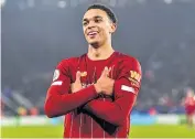  ??  ?? Man of the moment: Trent AlexanderA­rnold celebrates scoring Liverpool’s final goal as they crushed title rivals Leicester City 4-0 on Boxing Day