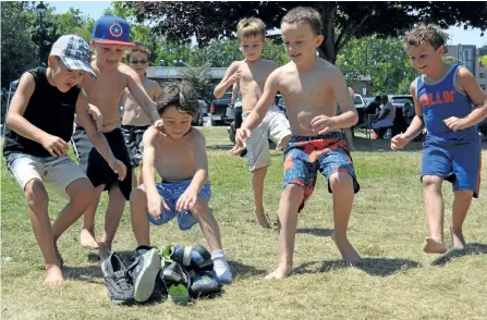  ?? PAT MARCHEN/ SPECIAL TO THE EXAMINER ?? The shoe race is not an Olympic sport, but it is a favourite event at Hiawatha First Nation picnics. Participan­ts race to a pile where their shoes are mixed up, find them, put them on and race back to the finish line. These young fellows were in the...