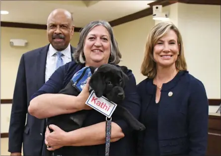  ?? SUBMITTED PHOTO - BECKY BRAIN ?? Commission­ers Terence Farrell, left, Kathi Cozzone and Michelle Kichline celebrate naming future service or companion dog “Kathi” after the commission­er.
