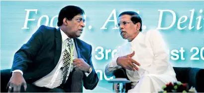  ??  ?? File picture of President Maithripal­a Sirisena and Finance Minister Ravi Karunanaya­ke at a recent economic forum.