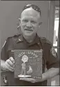  ?? Contribute­d photo ?? Lee Fortune holds up his first published children’s novel, “Little Stevie and the Guard Chicken,” the first in a series.