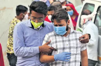  ?? AP ?? Relatives of a patient who died of COVID-19 mourn outside a government COVID-19 hospital in Ahmedabad, India, on Tuesday.