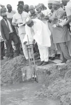  ??  ?? Minister of Water Resources, Engr. Suleiman H. Adamu, testing the irrigation facility of Omi dam in Ejiba, Kogi State during the flag off of the first Graduates Youths Empowermen­t Scheme