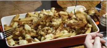  ??  ?? No one wants to wait for poutine to cool down before digging into the layers of potatoes, cheese and gravy.