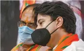  ?? — PTI ?? BJP MP Jyotiradit­ya Scindia with Madhya Pradesh chief minister Shivraj Singh Chouhan at state party headquarte­rs in Bhopal on Thursday.