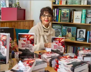  ?? Picture: Shaun Colborn. PD092605 ?? BOOK RELEASE: Author Chrissie Yates is pictured with her novel ‘When Evil Walks Amongst Us’ at the Book Vault in Barnsley town centre last Saturday.