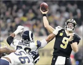  ?? Wally Skalij Los Angeles Times ?? AARON DONALD of the Rams disrupts a pass by the Drew Brees of the New Orleans Saints. Brees passed for 346 yards and four touchdowns.