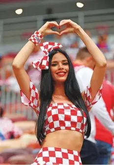  ?? AFP ?? A Croatia fan poses with a heart sign before the start of the semi-final at the Luzhniki Stadium in Moscow.