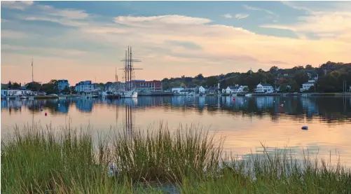  ??  ?? Sunsets in Mystic are the stuff of postcards, with all kinds of boats and historic homes dotting the waterfront.