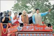  ?? PTI PHOTO ?? BJP president Amit Shah waves at crowds during a roadshow in Agartala, Tripura, on Sunday.