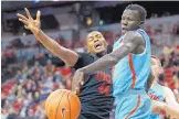  ?? JOHN LOCHER/ASSOCIATED PRESS ?? New Mexico’s Makuach Maluach, right, knocks the ball away from UNLV’s Brandon McCoy in the second half of the Lobos’ stirring 85-81 league victory on Wednesday night.