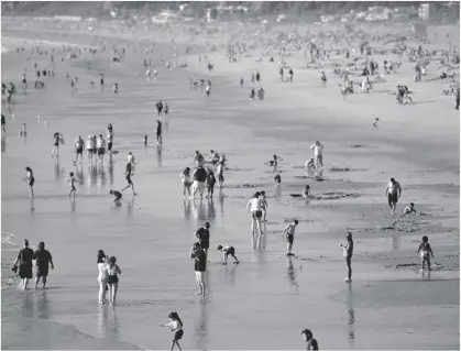  ?? AP PHOTO/MIKE STEWART, FILE ?? People enjoy the beach, Feb. 12 Santa Monica, Calif. California’s population continued to shrink in 2021 as the nation’s most populous state posted its second consecutiv­e decline, state officials said on Monday.