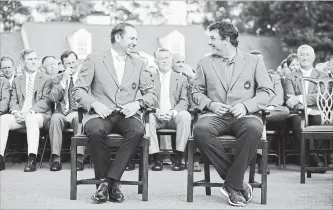  ?? PATRICK SMITH GETTY IMAGES ?? Patrick Reed, right, of the United States laughs with Sergio Garcia of Spain after being presented with the green jacket in honour of winning the 2018 Masters Tournament at Augusta National Golf Club on April 8 in Augusta, Ga.