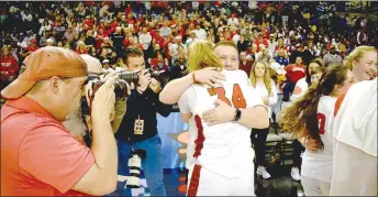  ?? ?? Mark Humphrey/Enterprise-Leader
Farmington head girls basketball coach Brad Johnson and senior Jenna Lawrence both broke into tears of joy during a celebrator­y hug after the Lady Cardinals won Class 4A State championsh­ip girls basketball by defeating Nashville, 65-61, in the state finals on Thursday, March 9, at Bank OZK Arena in Hot Springs.