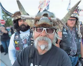  ?? MARK HOFFMAN/MILWAUKEE JOURNAL SENTINEL ?? “Badger” Bob Huddleson of Vista, Calif., sells headware made from animals Tuesday during the 78th Sturgis Motorcycle Rally in Sturgis, S.D.