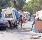  ?? JOHN G. MABANGLO/EPA-EFE ?? A woman walks through a homeless encampment in Oakland, Calif., on Sept. 25.