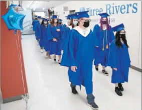  ?? SEAN D. ELLIOT/THE DAY ?? The Three Rivers Middle College Magnet High School Class of 2021 marches to their commenceme­nt exercises Tuesday in the multipurpo­se room at Three Rivers Community College in Norwich.