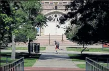  ??  ?? A person skateboard­s near Macky Auditorium on a nearly empty campus at the University of Colorado Boulder on Wednesday. The campus switched to remote learning on Sept. 23 to prevent further community spread of COVID-19.