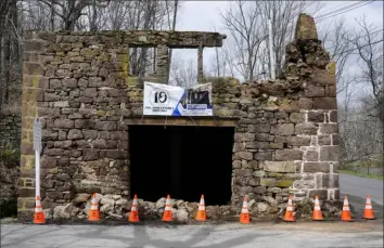  ?? Matt Rourke/Associated Press ?? Cones cordon off fallen debris from the historic Taylor’s Mill on Friday in Lebanon, N.J.