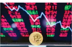  ?? —AFP ?? This file photo shows a visual representa­tion of the digital crypto-currency Bitcoin, at the “Bitcoin Change” shop in the Israeli city of Tel Aviv.