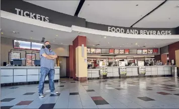  ?? James Franco / Special to the Times Union ?? Joe Masher, chief operating officer at Bow Tie Cinemas and president of the National Associatio­n of Theater Owners, stands in the vacant lobby of Movieland 6 in Schenectad­y. He expects most Bow Tie locations will be open on Friday.