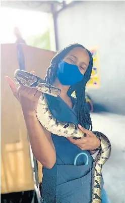 ??  ?? Hope Zoo Veterinari­an Dr. Szarianne Khan with one of their resident Ball Python snakes