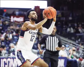  ?? Paul Connors / Associated Press ?? UConn’s Tyler Polley shoots against Long Island on Wednesday in Storrs.