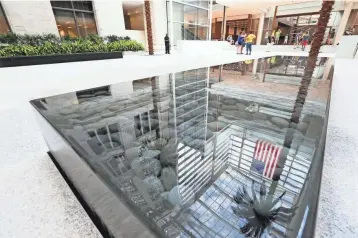  ??  ?? A reflective pool highlights the atrium area of Northweste­rn Mutual Life Insurance Co.’s new building.