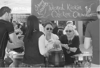  ?? SARAH ESPEDIDO/STAFF PHOTOGRAPH­ER ?? People line up to sample the New England-style chowder that Shirley Stamper brought to the Orlando Chowder Festival in Maitland on Sunday.