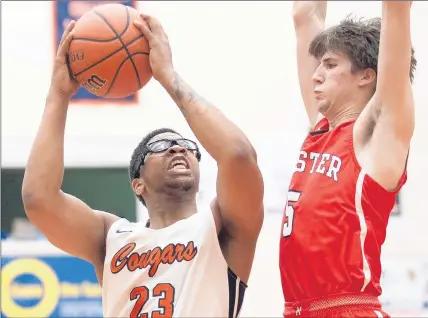  ?? PHOTOS BY KYLE TELECHAN / POST-TRIBUNE ?? West Side’s Parion Roberson (23) takes the ball up against Munster’s Bryce Schaum during the Class 4A West Side Sectional championsh­ip game on Saturday.