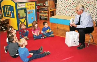  ?? MARTHA GEHRINGER — FOR DIGITAL FIRST MEDIA ?? Dr. David Szymanski talks to the pre-K at St. Francis Academy about keeping their teeth healthy because February is dental health month.