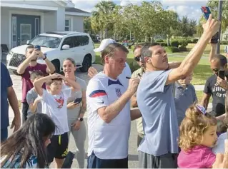  ?? SKYLER SWISHER/ORLANDO SENTINEL ?? About 40 supporters rallied to show their support for former Brazil President Jair Bolsonaro outside a vacation home where he is staying near Orlando.