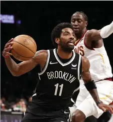  ?? GETTY IMAGES ?? BOSTON-BOUND: Brooklyn’s Kyrie Irving dribbles as Cleveland’s Caris LeVert defends during the first half of the Eastern Conference Play-In Tournament at Barclays Center on Tuesday night in Brooklyn.