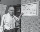  ?? ?? Church member George Hanna shows the cornerston­e of St. Mary’s Syriac Orthodox Church of Shrewsbury. The stone was first laid at the original church on Hawley Street in Worcester in 1923 and moved with the congregati­on to Shrewsbury.