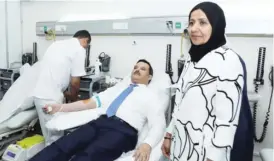  ?? — Photo by Joseph Shagra ?? KUWAIT: Health Minister Jamal Al-Harbi donates blood during the launch of the Sour AlWatan blood donation campaign yesterday.