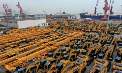  ?? Photograph: VCG/Getty Images ?? A vast car park of lorries and excavators for export at the port of Lianyungan­g in China’s Jiangsu province.