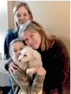  ?? AP ?? From left, Helen Welch, Christina Hartman and Monica Newhard with Zoey the bichon frise after her lucky escape from the talons of an eagle.