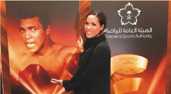  ?? Rasheda Ali twitter ?? Muhammad Ali’s daughter Rasheda posing next to a poster of her father in Jeddah on Wednesday, ahead of the World Boxing Super Series title bout.
