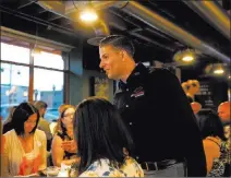  ?? K.M. Cannon ?? Las Vegas Review-journal @Kmcannonph­oto Lip Smacking Foodie Tours President Donald Contursi, standing, talks with a tour group at 7th & Carson in downtown Las Vegas.