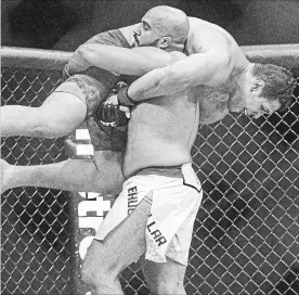  ?? CANADIAN PRESS FILE PHOTO ?? Se Luis Henrique of Brazil is lifted by Arjan Singh Bhullar of Canada during their mixed martial arts bout at UFC 215 in Edmonton on Sept. 9, 2017.