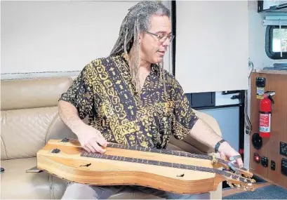  ?? TREVOR FRASER/ORLANDO SENTINEL PHOTOS ?? Mountain dulcimer player Bing Futch blends original music and covers at his gigs around Central Florida.