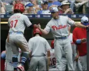  ?? AARON GASH — THE ASSOCIATED PRESS ?? Philadelph­ia Phillies’ Odubel Herrera (37) is congratula­ted by manager Gabe Kapler after scoring a run during the seventh inning of a baseball game against the Milwaukee Brewers.