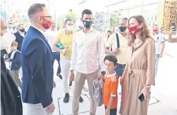  ?? — AFP photo ?? Djokovic (centre) and his wife Jelena Djokovic (right) are pictured during a visit to the Serbian pavillion at the Expo 2020 in Dubai.