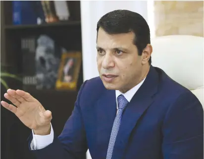  ?? (Reuters) ?? MOHAMMAD DAHLAN gestures in his office in Abu Dhabi, in 2016. Why is Abbas so afraid of him, who was once seen as his trusted ally and close confidant?